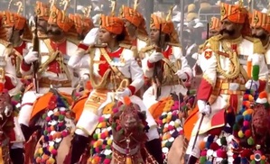 Female riders on decorated camels participate in R-Day parade