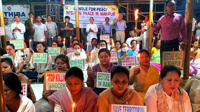 Manipuris in Tripura hold candlelight demonstration seeking normalcy in home state